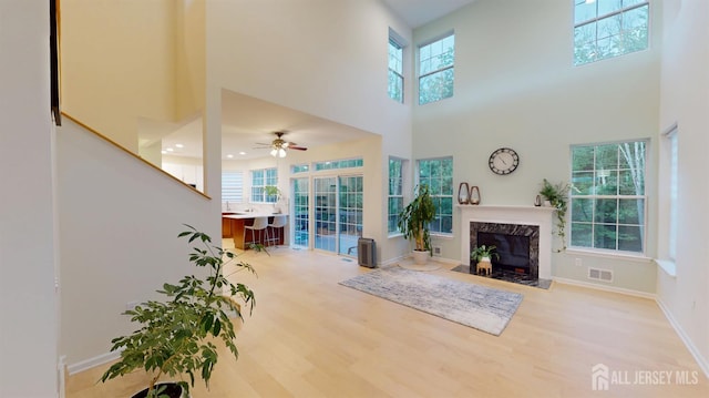 53 Kirschman Dr, Old Bridge, NJ 07747 - living room with a towering ceiling, healthy amount of natural light, wood finished floors, ceiling fan, and a fireplace