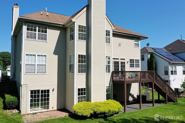 53 Kirschman Dr, Old Bridge, NJ 07747 - back of house featuring a chimney, a wooden deck, stairs, and a yard