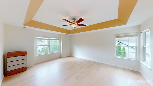 53 Kirschman Dr, Old Bridge, NJ 07747 - empty room with a raised ceiling, healthy amount of natural light, light wood-style floors, and a ceiling fan