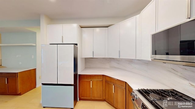 53 Kirschman Dr, Old Bridge, NJ 07747 - kitchen featuring stainless steel appliances, decorative backsplash, light countertops, and white cabinetry
