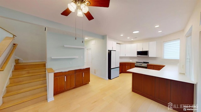 53 Kirschman Dr, Old Bridge, NJ 07747 - kitchen featuring freestanding refrigerator, range, open shelves, light countertops, and a peninsula