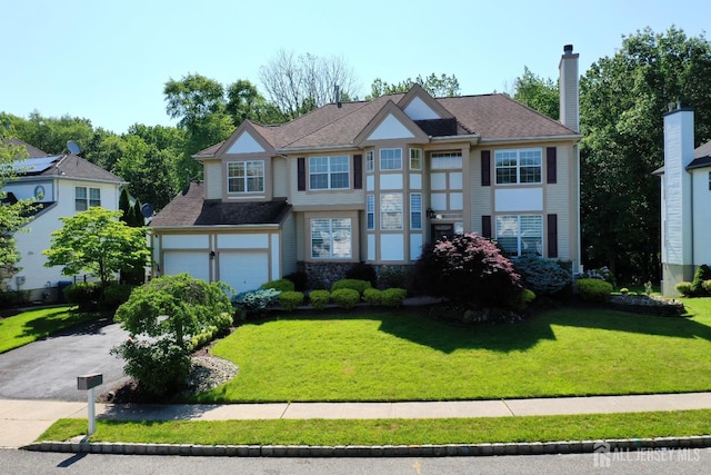 53 Kirschman Dr, Old Bridge, NJ 07747 - view of front of property with driveway, a front lawn, a garage, and a chimney