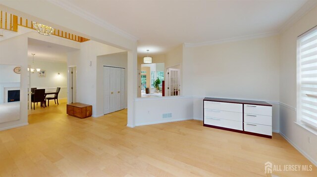 53 Kirschman Dr, Old Bridge, NJ 07747 - unfurnished room featuring light wood-style floors, a chandelier, plenty of natural light, and ornamental molding