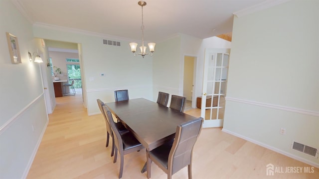 53 Kirschman Dr, Old Bridge, NJ 07747 - dining space with a chandelier, light wood finished floors, and crown molding