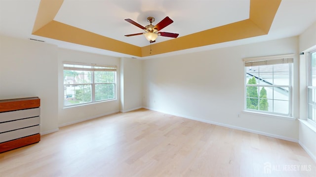 53 Kirschman Dr, Old Bridge, NJ 07747 - unfurnished room with a raised ceiling, healthy amount of natural light, light wood-style flooring, and a ceiling fan
