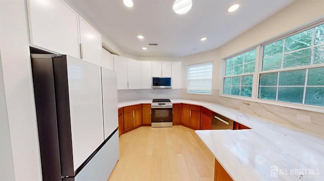 53 Kirschman Dr, Old Bridge, NJ 07747 - kitchen featuring appliances with stainless steel finishes, recessed lighting, light wood-type flooring, decorative backsplash, and brown cabinets