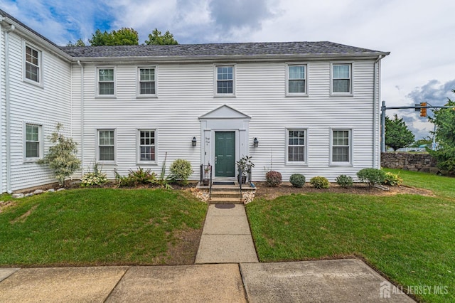 colonial home with a front yard