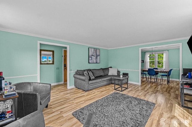 living room with wood-type flooring and ornamental molding