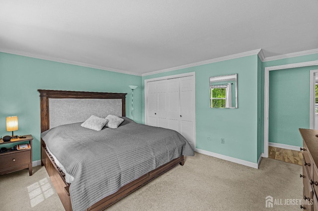 bedroom featuring a closet, crown molding, and light colored carpet