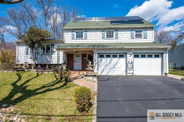 6 Mockingbird Rd, Edison, NJ 08820 - view of front of home featuring driveway, a front yard, a garage, solar panels, and a shingled roof