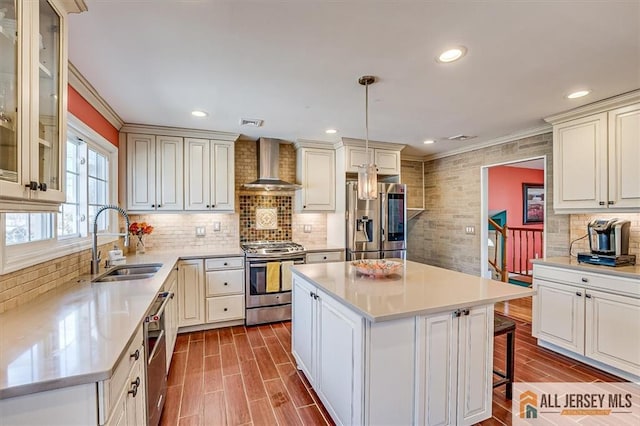 6 Mockingbird Rd, Edison, NJ 08820 - kitchen featuring stainless steel appliances, wall chimney range hood, a sink, light countertops, and ornamental molding