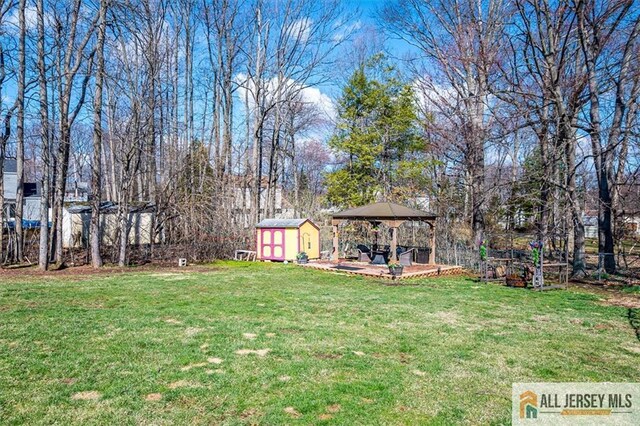 6 Mockingbird Rd, Edison, NJ 08820 - view of grassy yard featuring a gazebo and a patio area