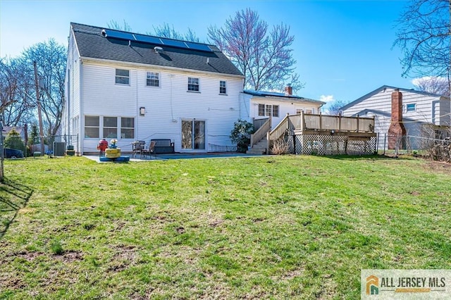 6 Mockingbird Rd, Edison, NJ 08820 - back of property featuring a wooden deck, a patio area, and central AC