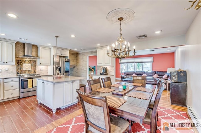 6 Mockingbird Rd, Edison, NJ 08820 - dining area featuring a baseboard radiator, light wood-style floors, a chandelier, and recessed lighting