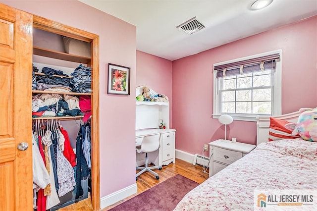 6 Mockingbird Rd, Edison, NJ 08820 - bedroom with wood finished floors, a closet, a baseboard heating unit, baseboards, and an office area