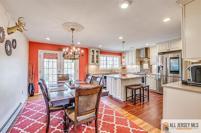 6 Mockingbird Rd, Edison, NJ 08820 - dining room featuring a baseboard heating unit, wood finished floors, recessed lighting, a chandelier, and french doors