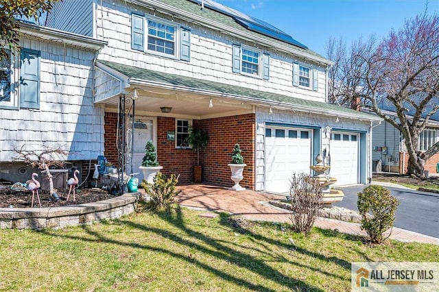 6 Mockingbird Rd, Edison, NJ 08820 - view of front facade featuring a garage, asphalt driveway, solar panels, a front yard, and a porch