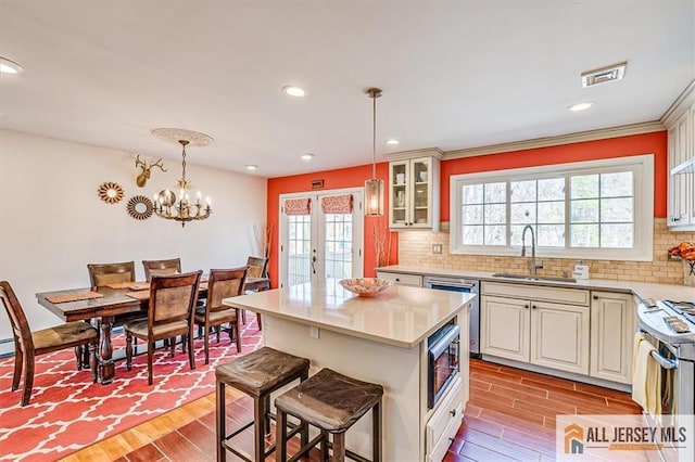 6 Mockingbird Rd, Edison, NJ 08820 - kitchen with a sink, wood finished floors, light countertops, stainless steel appliances, and backsplash