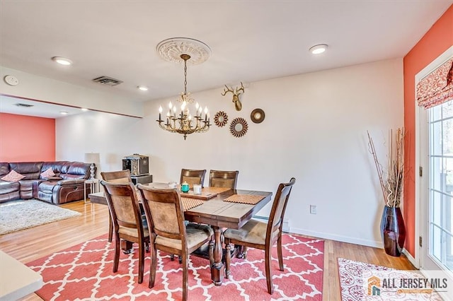 6 Mockingbird Rd, Edison, NJ 08820 - dining room with light wood finished floors, a chandelier, and baseboards