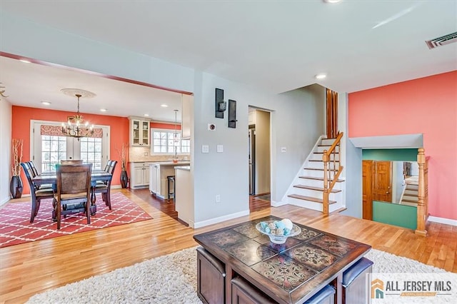 6 Mockingbird Rd, Edison, NJ 08820 - living room featuring stairway, light wood-style flooring, a chandelier, baseboards, and recessed lighting