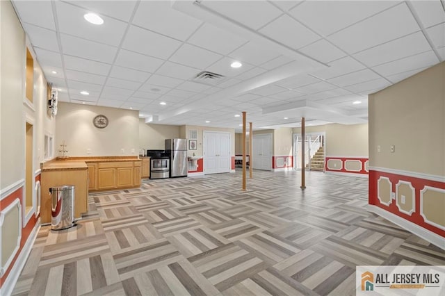 482 Spotswood Gravel Hill Rd, Monroe, NJ 08831 - finished below grade area featuring light carpet, freestanding refrigerator, a wainscoted wall, bar with sink, and stairway