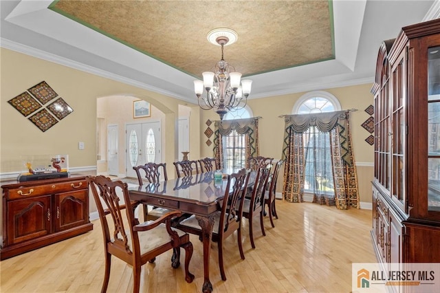 482 Spotswood Gravel Hill Rd, Monroe, NJ 08831 - dining space with a raised ceiling, arched walkways, a chandelier, light wood-style flooring, and healthy amount of natural light