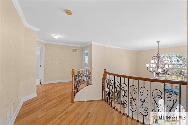 482 Spotswood Gravel Hill Rd, Monroe, NJ 08831 - hallway featuring an upstairs landing, a chandelier, wood finished floors, ornamental molding, and baseboards
