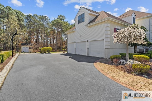 482 Spotswood Gravel Hill Rd, Monroe, NJ 08831 - view of side of property featuring asphalt driveway and a garage