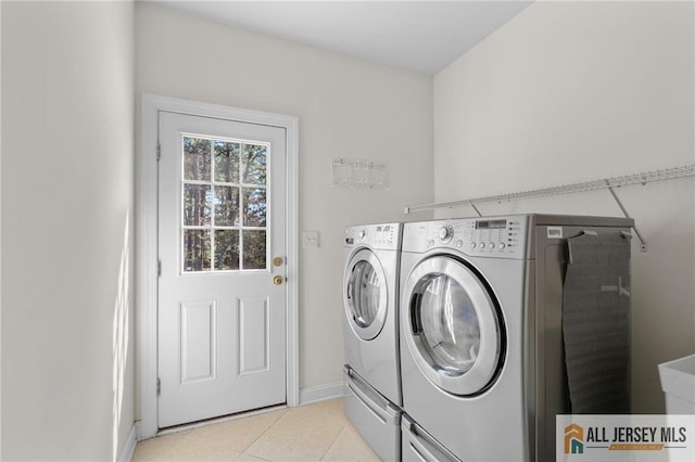 482 Spotswood Gravel Hill Rd, Monroe, NJ 08831 - washroom featuring washer and clothes dryer, light tile patterned floors, and baseboards