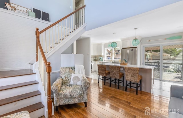 interior space featuring light wood-style flooring, a healthy amount of sunlight, and stairway