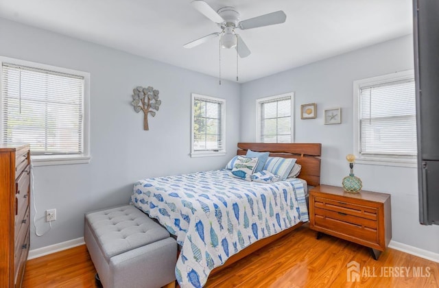 bedroom with baseboards, a ceiling fan, and wood finished floors