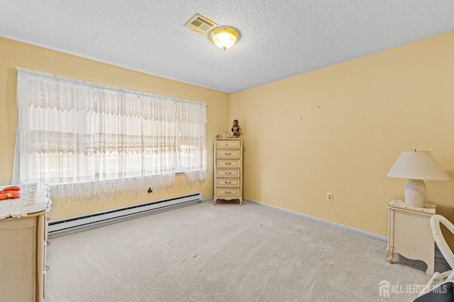 unfurnished bedroom with light carpet, a textured ceiling, multiple windows, and a baseboard heating unit