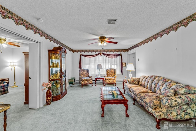 carpeted living room with baseboard heating, ceiling fan, and a textured ceiling