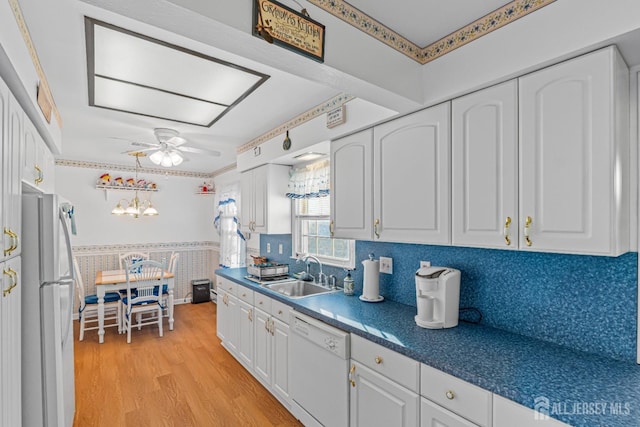 kitchen with white cabinetry, sink, ceiling fan, white appliances, and light wood-type flooring