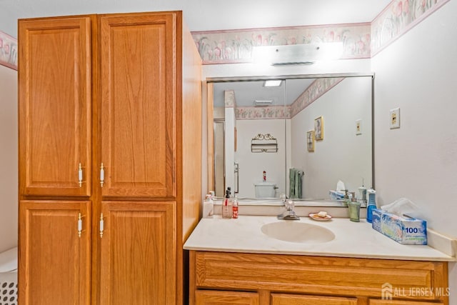 bathroom featuring vanity and toilet