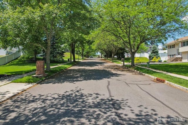 35 Poet Dr, Matawan, NJ 07747 - view of asphalt street with sidewalks, curbs, and a residential view