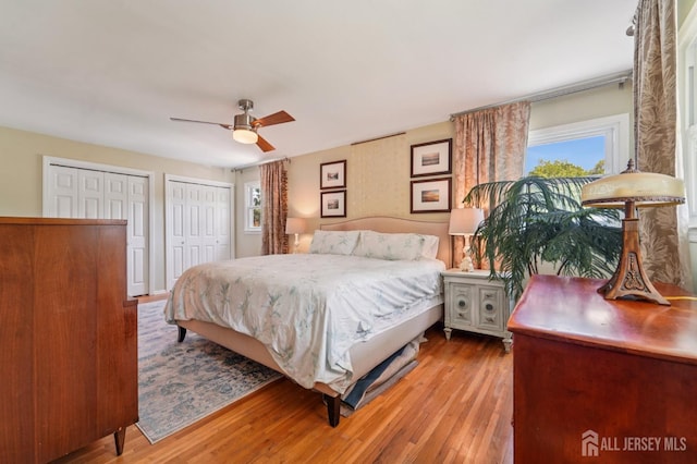 35 Poet Dr, Matawan, NJ 07747 - bedroom with two closets, wood finished floors, a ceiling fan, and access to outside