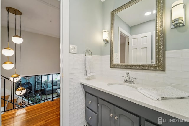 35 Poet Dr, Matawan, NJ 07747 - bathroom with vanity, decorative backsplash, and wood finished floors