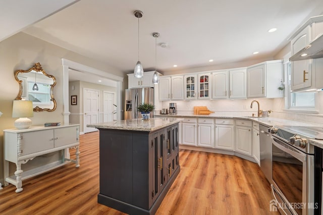 35 Poet Dr, Matawan, NJ 07747 - kitchen with appliances with stainless steel finishes, white cabinetry, glass insert cabinets, pendant lighting, and recessed lighting