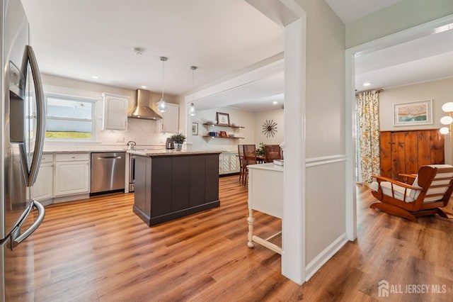 35 Poet Dr, Matawan, NJ 07747 - kitchen with appliances with stainless steel finishes, wall chimney range hood, white cabinets, light wood-style flooring, and recessed lighting