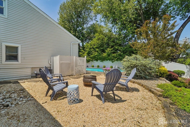 35 Poet Dr, Matawan, NJ 07747 - fenced backyard featuring an outdoor fire pit