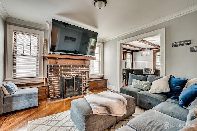 1072 Salem Ave, Hillside, NJ 07205 - living area with a chandelier, ornamental molding, wood finished floors, a fireplace, and plenty of natural light
