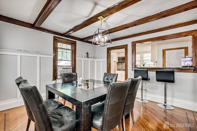 1072 Salem Ave, Hillside, NJ 07205 - dining room with a decorative wall, wood finished floors, beamed ceiling, a wainscoted wall, and cooling unit