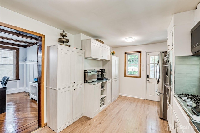 1072 Salem Ave, Hillside, NJ 07205 - kitchen with light wood-style flooring, stainless steel gas cooktop, white cabinets, and refrigerator