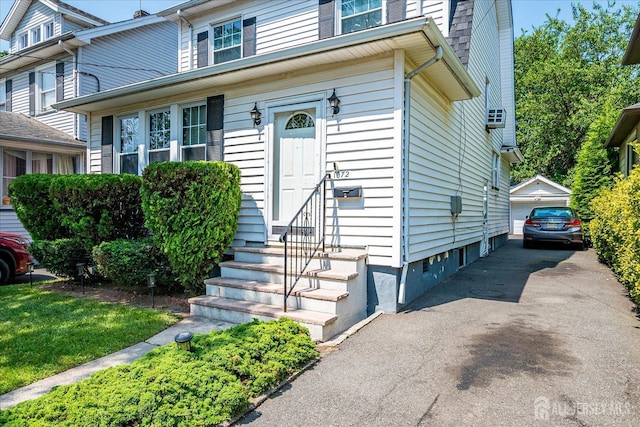 1072 Salem Ave, Hillside, NJ 07205 - view of front of home featuring entry steps, an outbuilding, and a garage