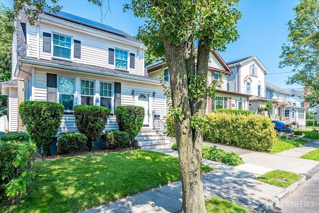 1072 Salem Ave, Hillside, NJ 07205 - view of front of home featuring roof mounted solar panels and a front yard