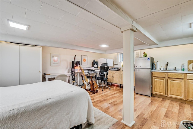 1072 Salem Ave, Hillside, NJ 07205 - bedroom with freestanding refrigerator, light wood finished floors, and an office area