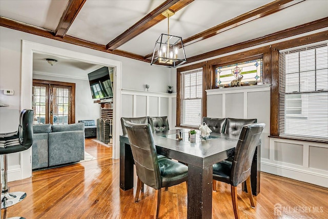 1072 Salem Ave, Hillside, NJ 07205 - dining area featuring a decorative wall, wood finished floors, a chandelier, beamed ceiling, and ornamental molding