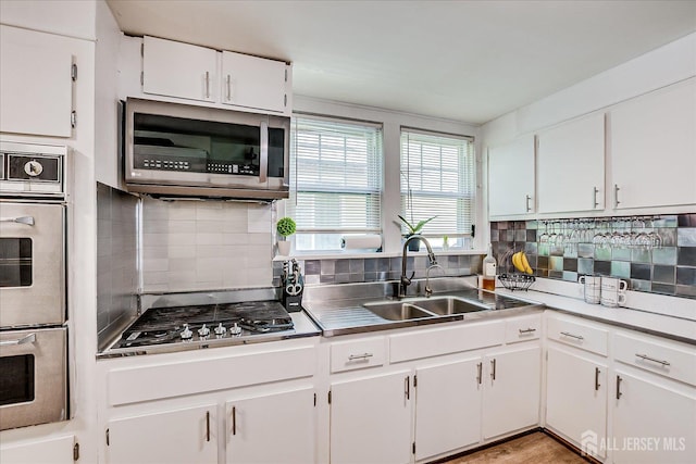 1072 Salem Ave, Hillside, NJ 07205 - kitchen featuring appliances with stainless steel finishes, tasteful backsplash, and white cabinets
