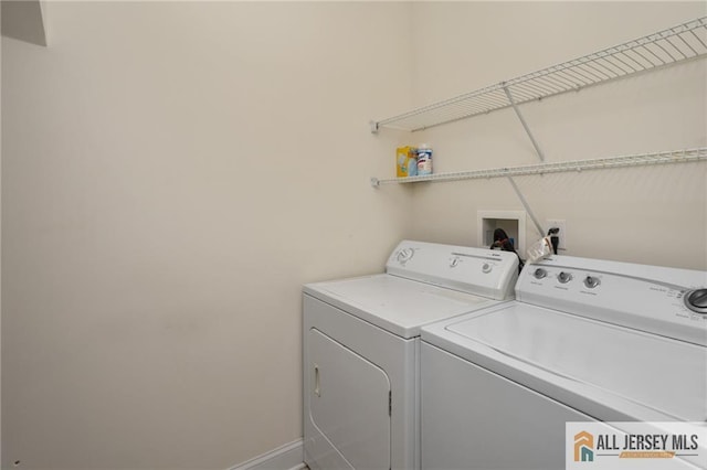 laundry room with washing machine and clothes dryer